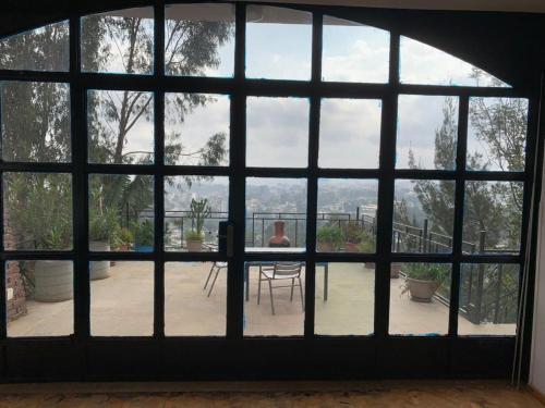 a room with a large window with a view of a patio at SSHC Apartments in Addis Ababa