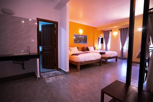 a hotel room with two beds and a mirror at Daun Penh Palace Boutique in Phnom Penh