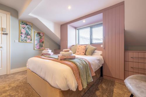 a bedroom with a bed with two stuffed animals on it at Boutique Stays at 78 in Bangor