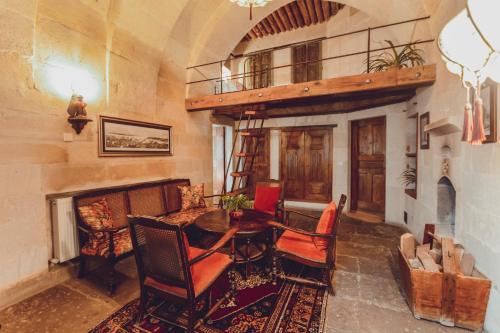 a living room with a wooden table and chairs at Kale Konak Cappadocia in Uchisar