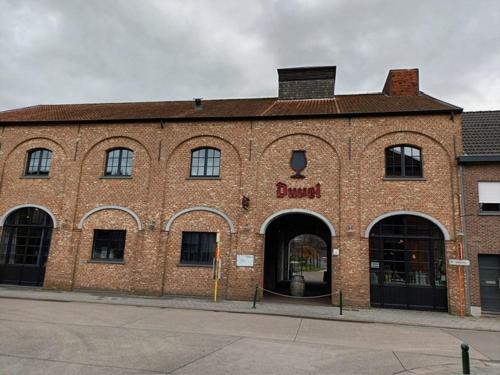 een groot bakstenen gebouw met een bordje op bij The best known village of Belgium in Puurs