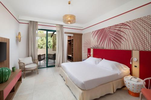 a bedroom with a white bed and a red wall at Tanka Selected in Villasimius
