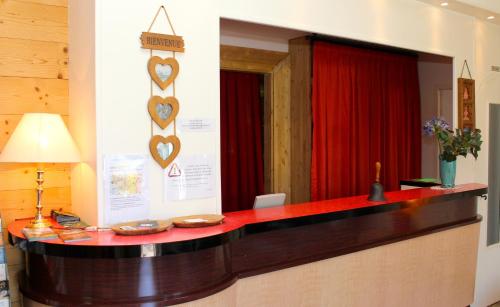 a reception desk in a room with hearts on the wall at Hôtel du Château in Annecy