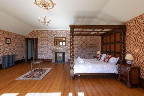 a bedroom with a bed and a chandelier at Magnificent Period Country House in Rothley