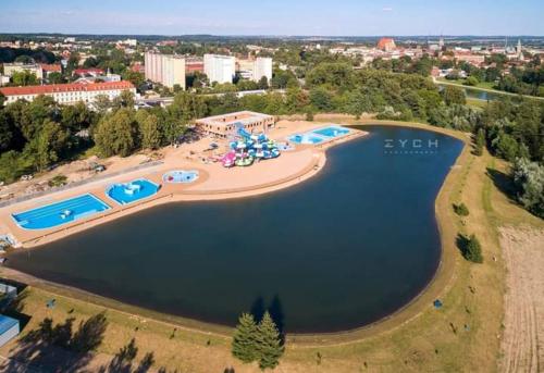 an aerial view of a large lake with a resort at Apartament DANI in Nysa