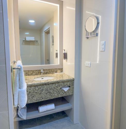 a bathroom with a sink and a mirror at La Quinta by Wyndham Quito in Quito