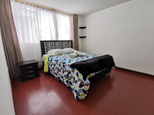 a bedroom with a bed and a window at Aparta-estudio centro cerca plaza de bolívar Tunja in Tunja