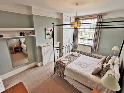 a bedroom with a bed and a lamp and a window at Beacon View in Ivinghoe