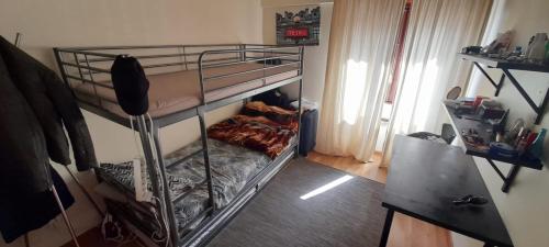 a bedroom with two bunk beds in a room at SHARED APARTMENT WITH PRIVATE ROOM in Bobadela