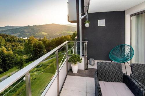 a balcony with chairs and a view of the mountains at Apartview Bukowa II by Rent like home in Wisła
