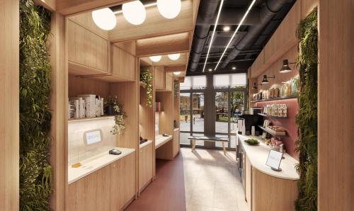 a salon with plants on the walls at YOTELPAD London Stratford in London