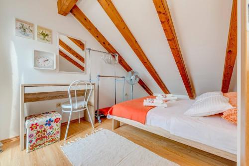 a bedroom with a bed and a chair in a room at Rustic Villa Florice with a pool in Lećevica