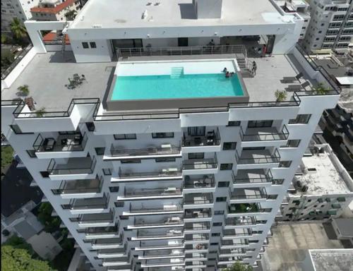 an aerial view of a building with a swimming pool at Bella Vista cozy-deluxe near Downtown center in Santo Domingo