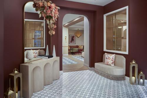 a living room with purple walls and a large mirror at Hotel Vesper, Houston, a Tribute Portfolio Hotel in Houston