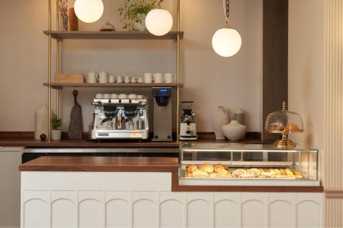 a kitchen with a counter with a bakery with pastries at Hotel Vesper, Houston, a Tribute Portfolio Hotel in Houston