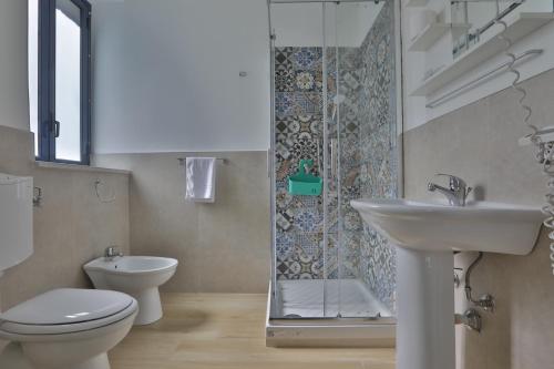 a bathroom with a sink and a toilet and a shower at Casa Galati in Palermo