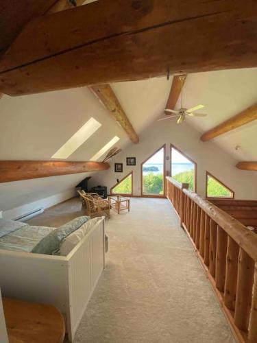 a room with a bed and a ceiling fan at Privacy @ Bras d’Or Lake Eagle House Chalet in St. Peter's