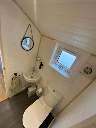 a small bathroom with a toilet and a window at Cow Hill Pod in Fort William