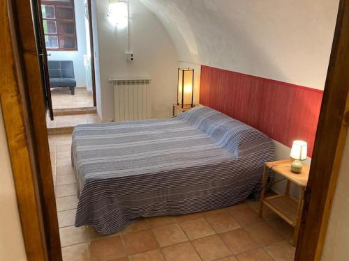 a bedroom with a large bed with a red wall at il patio mini appartamento in Pantelleria