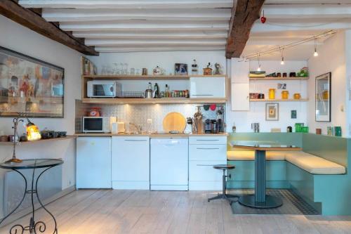 uma cozinha com armários azuis e uma mesa em L'Opéra , appartement cosy, centre historique em Rennes