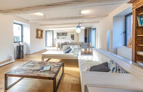 a living room with a couch and a table at Villa Asselin - Belle maison en pierre -4 chambres in Beaussais sur Mer