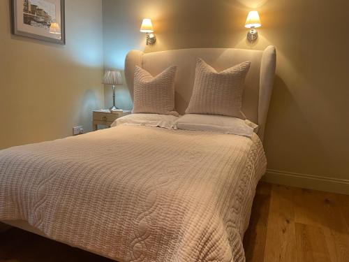 a bedroom with a bed with two pillows on it at Ty Llew Lodge in Abergavenny