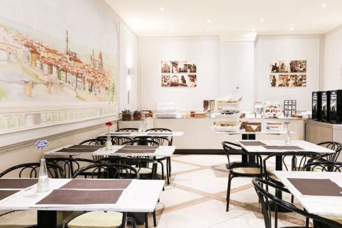 a classroom with tables and chairs in a restaurant at Albergo Firenze in Florence