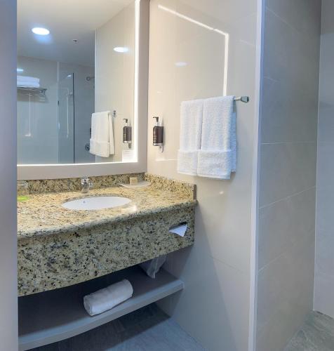 a bathroom with a sink and a mirror at La Quinta by Wyndham Quito in Quito