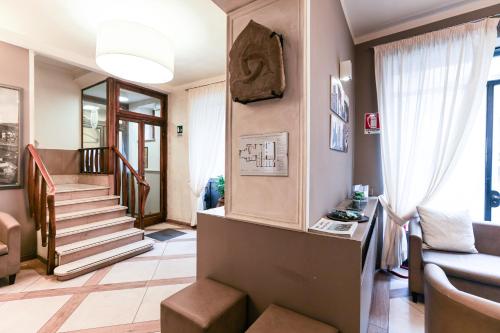 a living room with a staircase and a couch at Albergo Firenze in Florence