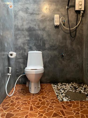 bagno con servizi igienici e pavimento in pietra. di Shaya Resort a Pai