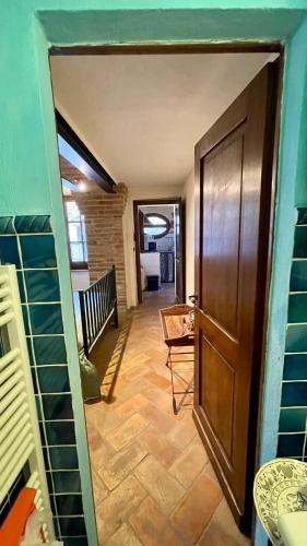 a view of a hallway with a door and a room at Il Giardino degli Ulivi in Chiusure
