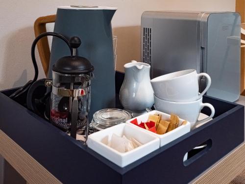 a black drawer with a tea pot and a coffee maker at By the River in Glasbury