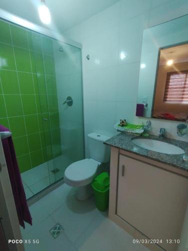 a bathroom with a toilet and a sink and a shower at London Family home in Cochabamba