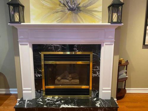 a fireplace with a flower on the top of it at 4 Bedroom House in Mississauga in Mississauga