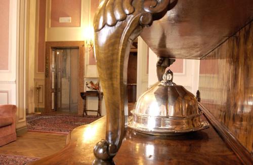 a metal bell sitting on top of a table at Grand Hotel Liberty in Riva del Garda