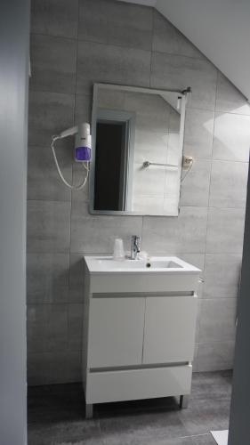 a bathroom with a white sink and a mirror at Hotel Senhor de Matosinhos in Matosinhos
