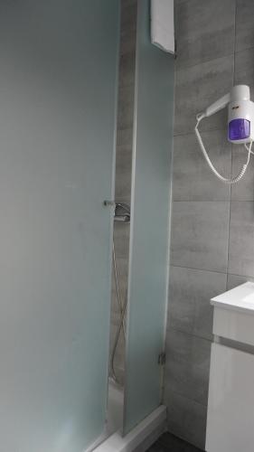 a bathroom with a shower with a glass door at Hotel Senhor de Matosinhos in Matosinhos