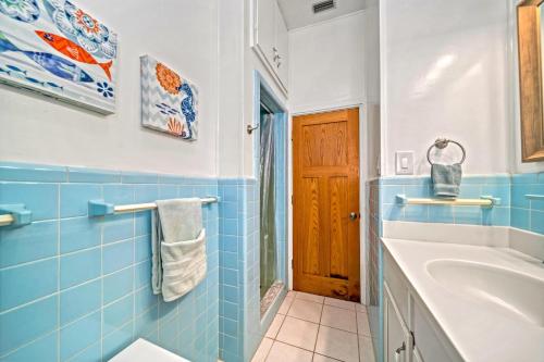 a blue tiled bathroom with a tub and a sink at Pelicans Place - 117A in Siesta Key