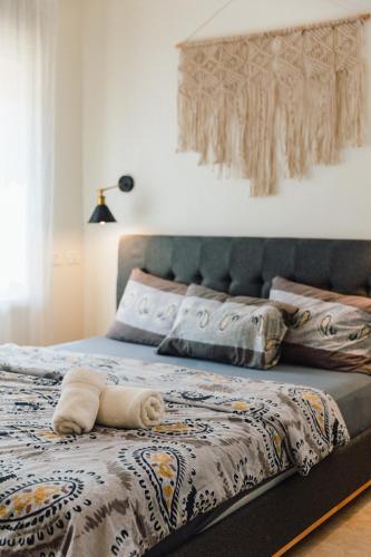 a bed with a blanket and a towel on it at אבן על הנחל in Merhav Am
