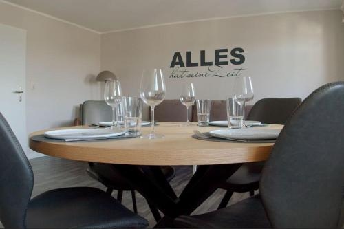 a wooden table with wine glasses on top of it at Apartment Göhrenglück - groß - zentral - strandnah in Göhren