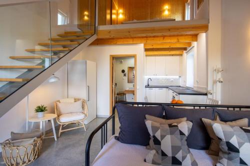 a small apartment with a staircase and a living room at Quinta da Capelinha Agroturismo in Tavira