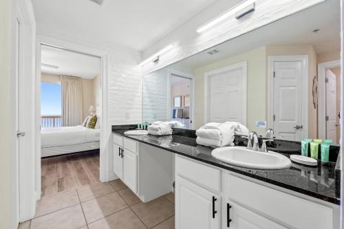 a bathroom with a sink and a large mirror at Calypso Resort and Towers #801-W by Book That Condo in Panama City Beach