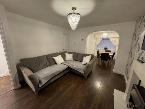 a living room with a couch and a table at Modern 3 Bedroom House Close to Liverpool Centre in West Derby