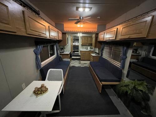 an rv living room with a table and a couch at Retreat (rinconcito) in Hildale