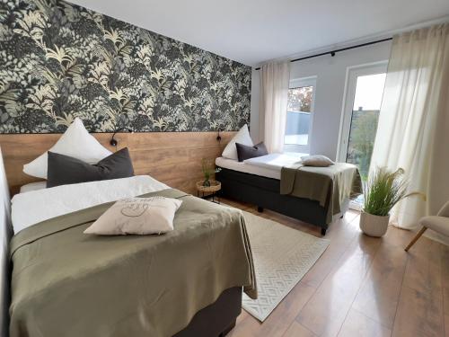 a bedroom with two beds and a window at Große Wohnung & Apartment Sauna & 4 Badezimmer Netflix in Petershagen