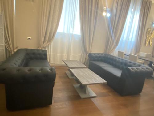 a living room with two couches and a coffee table at Residenza Segrate Centro Novegro in Segrate