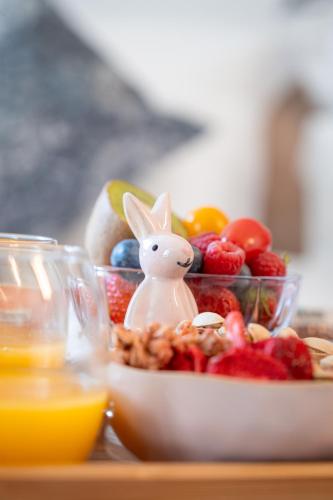 a bowl of fruit with a bunny figurine on top of it at GREEN PARK HOTEL PARIS in Paris
