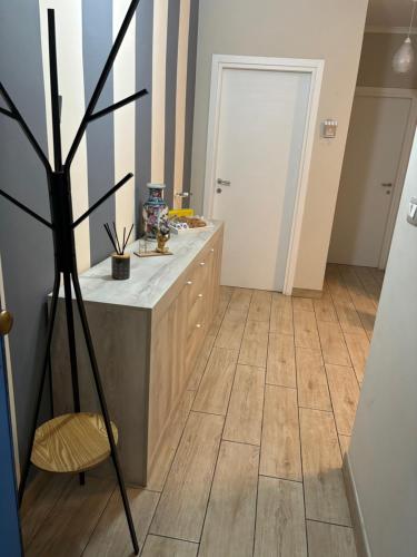 a kitchen with a counter and a wooden floor at Casa dolce casa in Sanremo