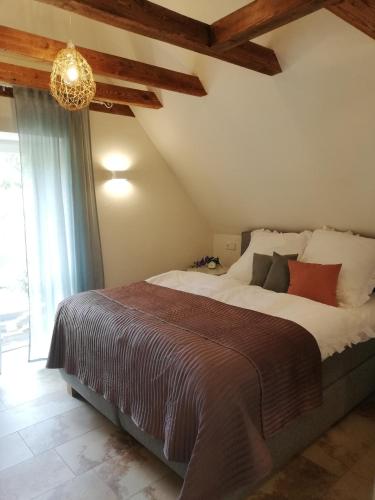 a bedroom with a large bed and a chandelier at Ferienwohnung Carlotta in Freyburg