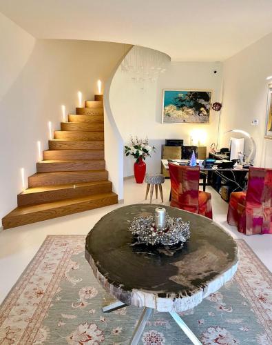 a living room with a table and a staircase at Villa Francesca Relais in Gradara